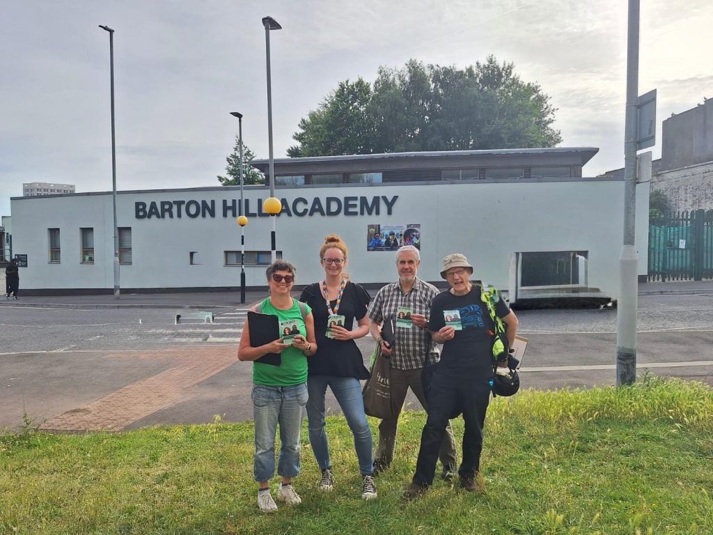 Green campaigners outside Barton Hill Academy with clipboards