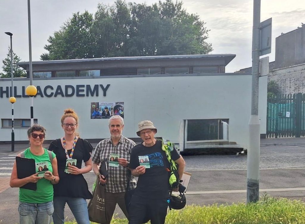 Green campaigners outside Barton Hill Academy with clipboards